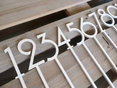 the numbers are placed on wooden boards with metal bars