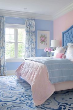 a bedroom decorated in blue and pink tones