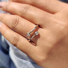 a woman's hand with a diamond ring on it