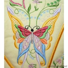 an embroidered butterfly with flowers on it