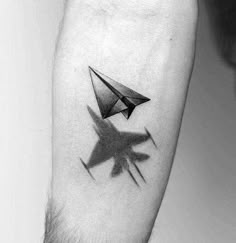 a black and white photo of a man's arm with an origami tattoo on it