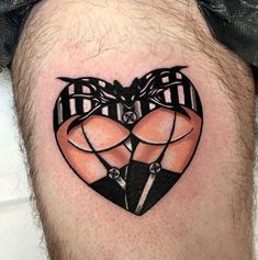 a man's leg with a tattoo on it that has an image of two people in the shape of a heart