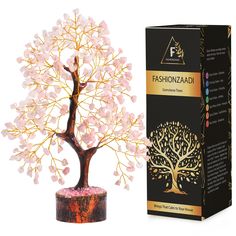 a small tree with pink flowers in it next to a cardboard box and packaging for fashionzaad