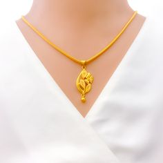 This exquisite pendant is crafted from 22k gold, weighing 2.8 grams, and showcases a stunning yellow gold finish. The design features a palatial blooming floral motif, extending 1.5 inches in length, embodying both elegance and intricate detailing. Perfect for adding a touch of sophistication and timeless beauty to any ensemble, this floral pendant can serve as a central piece for special occasions or a luxurious addition to everyday wear. Note: The chain is not included, giving you the freedom to pair it with a chain that complements your style. PRODUCT DETAILS Gold Purity(karat): 22k Gold Weight(grams): 2.8 Item Finish: Yellow Gold Pendant Length: 1.5" Chain: Not Included Traditional Yellow Gold Flower Pendant Necklace, 22k Yellow Gold Flower Pendant Necklace, 8 Grams Gold Chain, Bridal Jewelry Necklace, Precious Stones Rings, Diamond Pendant Sets, Gold Chain Design, Modern Bracelets, Fancy Necklace