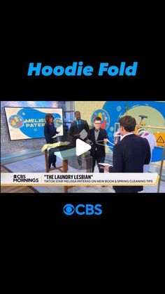 two men are talking to each other in front of a tv screen with the words hoodie fold on it