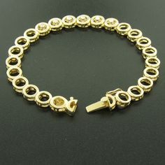 Here we have a beautiful 7 inch gold bracelet with diamonds. The bracelet is solid 14k yellow gold and features 24 round links. The 6 center links each feature a round brilliant cut diamond prong set in the middle. The other 18 links are simple, round, open links. The bracelet is secured with a box-like clasp and tight safety latch. A simple yet beautiful gold and diamond bracelet. Enjoy! Material: 14k Solid Yellow Gold Weight: 17.1 Grams Stone(s): (6) Natural Genuine Diamonds - Round Brilliant Fine Jewelry Tennis Bracelet With Solid Link Construction, Round Gold Bracelet With Solid Link Construction For Anniversary, Round Gold Bracelet With Solid Link For Anniversary, Round Gold Anniversary Bracelet With Solid Link, Anniversary Gold Bracelet With Solid Link, Gold Tennis Bracelet With Brilliant Cut, Cubic Zirconia Diamond Bracelet With Solid Link, Gold Jewelry With Prong Setting And Oval Link, Gold And Diamond Bracelet