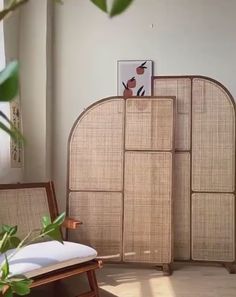 a room with two chairs and a bamboo screen