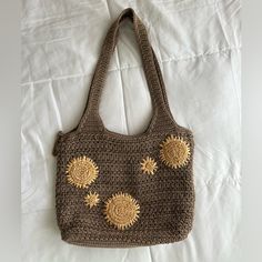 a brown crocheted bag with sunflowers on it