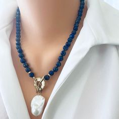 "Elegant everyday necklace made of beautiful blue Lapis Lazuli beads and freshwater baroque pearl charm, i added a gold bronze artisan toggle closure and gold filled donuts details. It is hand knotted the traditional way with a navy blue thread to separate the beads from each other. MATERIALS Lapis lazuli beads 6-7mm Baroque pearl  Artisan Gold bronze Gold filled Length is 20\"inches [51cm] All Loulia Pearl Jewelry orders are carefully packaged in a jewelry box with foam insert and secured with Blue Pearl Necklaces With Gemstone Beads, Blue Pearl Necklace With Natural Stones, Blue Beaded Necklaces With Pearl Pendant, Blue Beaded Necklace With Pearl Pendant, Handmade Blue Pearl Pendant Necklace, Handmade Blue Pendant Pearl Necklace, Blue Pearl Necklace With Natural Stones As A Gift, Blue Pearl Necklace With Natural Stones For Gift, Blue Beaded Pearl Necklaces With Pearl Pendant