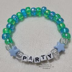 Holographic Blue And Holographic Green Yellow Pony Bead Bracelet "Party" With Clear Glittery And Solid Blue Star Bead Accents Double Stranded Elastic Kandi Bracelet Perfect For Emo, Scene, Y2k, Rave, Festival, Goth, Pastel Goth, Egirl, Gamer, Lgbt Pride Aesthetics. Elastic Bracelet Has Fair Stretch. Model Wrist 6.5" Model Hand 7.5" Please Check Measurements For Both. Please Do Not Exceed 8" Width, Elastic Will Break More Sizes Will Be Included Soon. Stock And Supplies Are Limited. Original Handm Trendy Beaded Bracelets With Tiny Beads For Parties, Party Bracelets With Colorful Round Beads, Colorful Beaded Bracelets For Party, Adjustable Beaded Bracelets With Spacer Beads For Party, Trendy Blue Beaded Bracelets For Party, Trendy Turquoise Bracelets For Party, Adjustable Blue Party Bracelets, Party Adjustable Beaded Friendship Bracelets, Party Stretch Bracelet With Spacer Beads