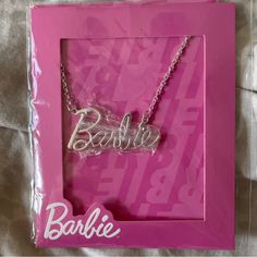 a necklace with the word barbie on it in a pink frame and white lettering that reads barbie