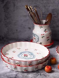 two bowls with utensils in them on a table