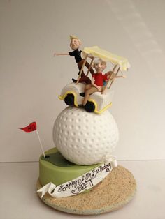 a golf themed cake with two people on top