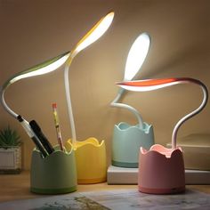 three different colored lamps sitting on top of a table