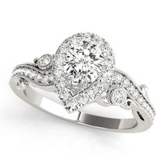 a white gold ring with diamonds on the sides and an oval center stone in the middle