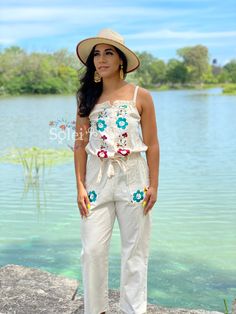 This modern style jumpsuit with beautiful traditional embroidered flowers is the perfect look for this season. It is a slim fitting romper with elastic on the back, buttons in the front and a tie around the waist. It also has embroidered pockets on each side. This jumpsuit is hand embroidered in Silk Thread with love for you by Mexican Artisans. Embroidered Cotton Jumpsuits And Rompers For Spring, Fitted Cotton Jumpsuit For Beach, Spring Festival Jumpsuits And Rompers, Casual Embroidered Jumpsuits And Rompers For Spring, Embroidered Cotton Jumpsuits And Rompers For Summer, Embroidered Fitted Jumpsuits And Rompers For Spring, Spring Embroidered Fitted Jumpsuits And Rompers, Embroidered Fitted Sleeveless Jumpsuits And Rompers, Cotton Jumpsuits And Rompers For Summer Festivals