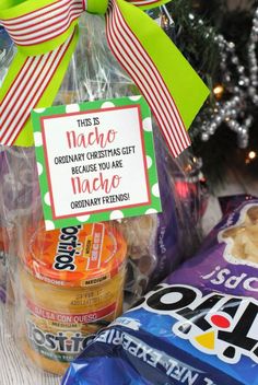 some candy and snacks are sitting on a table next to a christmas ornament