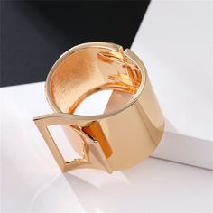 Bring a shinning finish to your favorite ensembles by decorating your wrist with this textured bangle made from a 18k gold-plated metal. 0.86" W x 2.40" diameter Hinge closure 18k gold-plated copper Trendy Gold Cuff Bracelet For Fashion, Trendy Gold Metal Bangle, Gold Metal Bangle As Fashion Accessory, Adjustable Metal Bangle Jewelry, Gold Metal Bangle, Gold Bangle Bracelets As Fashion Accessory, Gold Bangle Bracelet As Fashion Accessory, Trendy Gold Bangle Bracelet For Formal Occasions, Metal Cuff Bracelet For Formal Occasions