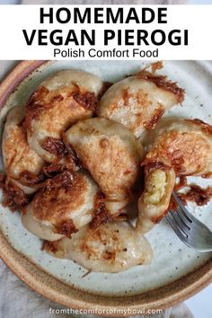 homemade vegan pierogi on a white plate with a fork and text overlay reads, homemade vegan pierogi polish comfort food