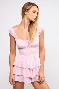 Bring some playful energy to your summer wardrobe with the Laney Pink Tiered Ruffle Romper Dress! Made from pink clip dot fabric, this romper features wide straps, a smocked waist, and tiered ruffle shorts. The ruched bust and front tie detail add a touch of unique charm. Pair it with cowgirl boots and rock it at your next summer concert! DETAILS & FIT Stretchy Fitted Waist. Pull on Design. 100% Rayon. Lining: Polyester. Clip Dot Fabric. Dry Clean for Best Results. Imported. Mini Dress Cocktail, A Line Mini Dress, Ruffle Summer Dress, Dress Cocktail Party, Cocktail Party Dresses, Ruffle Romper, Cap Dress, Solid Color Dress, Mini Dresses For Women