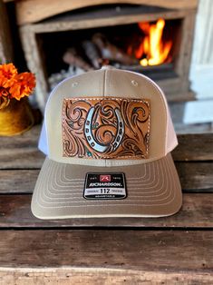 Western Trucker Hat With Flat Bill For Country Events, Western Flat Bill Trucker Hat For Country Events, Western Style Trucker Hat For Country Events, Western Trucker Hat With Leather Patch, Western Style Adjustable Trucker Hat With Leather Patch, Western Snapback Hat With Curved Brim For Rodeo, Country Style Snapback Hat For Rodeo With Flat Brim, Western Snapback Hat For Ranch, Western Brown Trucker Hat With Flat Bill