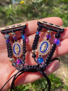 * Handmade  *Fits any 30mm,40mm,41mm, 45mm Size Watch *With added Virgencita Charms  *Added marble Blue and Purple Beads *All sales are final. No exchanges or return. if any issues arise, I would be more than happy to help. Just send a direct message Adjustable Black Beaded Apple Watch Band, Handmade Black Watch Accessories For Gift, Handmade Black Watch Bands As Gift, Handmade Black Watch Accessories As Gift, Handmade Black Jewelry For Personal Use, Handmade Blue Watch Bands As Gift, Customizable Adjustable Blue Watch Bands, Adjustable Black Watch Accessories As Gift, Handmade Black Apple Watch Band As Gift