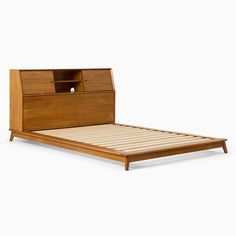 a bed with a wooden headboard and night stand on it's side, against a white background