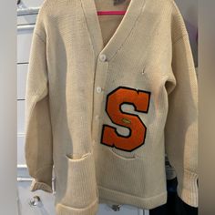 Rare Fine. Oversized Vintage Unisex Syracuse Letterman Cardigan. Some Stain Damage. 100% Wool. Oversized V-neck Vintage Cardigan, White Fall Cardigan For College, White Cardigan For College In Fall, Oversized Retro Long Sleeve Cardigan, Vintage Oversized V-neck Outerwear, Vintage White V-neck Outerwear, Oversized Vintage V-neck Cardigan, Vintage Oversized Outerwear With V-neck, Retro Cotton V-neck Outerwear