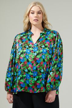 Add a pop of a colorful touch to your outfit of the day with the Destine Floral Hathaway Split Neck Long Sleeve Blouse! It features a ruffle split neckline framed by billowing balloon sleeves. The bodice maintains a relaxed fit and can be styled tucked into your favorite high waisted pants. This top is perfect for anything from day parties to dinner with friends.- Split neckline- Elastic cuffs - Lined- Balloon sleeves- Color: Green blue fuchsiaSize + Fit - Model is 5'8" and wearing size XS- Meas Green V-neck Top With Vibrant Print, Green Floral Print Blouse With Relaxed Fit, Green Long Sleeve Tops With Floral Print, Vibrant Green Fall Top, Vibrant Long Sleeve Tops For Day Out, Vibrant Green Blouse For Spring, Green Top With Vibrant Print For Fall, Vibrant Green Spring Tops, Green Blouse With Vibrant Print