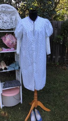 Cute ditsy floral day dress. Could be worn as long open blouse too.  Blue flowers on white background with lace trimmed sleeves.  Made in England. Measurements taken with garment laying flat (x2 for circumference where applicable) Shoulder to shoulder 14" Pit to Pit 21" Waist 23" Sleeve 11" Length 40" Long Sleeve Vintage Dress With Floral Print For Summer, Cotton Dresses With Bishop Sleeves For Spring, White Casual Vintage Dress For Daywear, Vintage Cotton Dress With Bishop Sleeves, White Long Sleeve Cotton Vintage Dress, White Floral Print Dress With Bishop Sleeves, White Cotton Long Sleeve Vintage Dress, Pastoral Prairie Dress For Spring Garden Party, White Vintage Dress With Floral Print