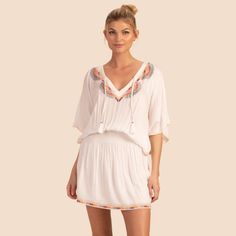 Drapey, White Rayon Adds Chic Style To This Vacation-Ready Tunic, While Colorfully Intricate Embroidery Adds A Fun Summer Feel For Easy Versatility. Pair This Tunic Cover-Up With Your Favorite Swimsuit For An Easy Beach-To-Bar Look, Or Dress It Up With Statement Earrings And Heeled Sandals For A Balmy Vacation Evening. Features- V-Neck Front Embroidered Neckline And Hem Short Dolman Sleeves Smocked At Natural Waist Blouson Waist Peplum-Style Hem 100% Rayon Semi-Sheer White V-neck Smocked Dress With Smocked Back, White Smocked Dress For Vacation, White Smocked Dress For Beach, White Smocked Dress For The Beach, Beach Dresses With Smocked Cuffs And V-neck, Flowy Beach Dress With Smocked Cuffs, Bohemian White Dress With Smocked Back, Bohemian Smocked V-neck Dress For Brunch, Bohemian Smocked Dress For Daywear