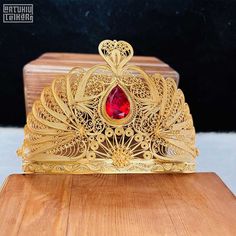 22k Gold-Plated woman's crown, 925 Sterling Silver filigree ruby bridal crown, turkish telkari openwork jewellery, luxury Mardin jewelry. IF YOU WANT THIS PRODUCT IN SILVER COLOR PLEASE SEE VARIATIONS. * Material: 925 Sterling Silver - 22K Gold Plated, Zircon. * Weight: 130 grams. IMPORTANT: * Our products are 100% handmade and can personalized. * Because this is a handicraft our shipping time takes 10 working days. * The product is sent with a gift box. * Free shipping worldwide * Delivery time Wedding Jewelry With Crown Design, Gold Ceremonial Crown With Structured Shape, Ceremonial Gold Crown With Structured Shape, Gold Crown Design Headpiece With Pinched Crown, Elegant Ceremonial Crown Headpieces, Gold Crown For Gift With Structured Shape, Gold Structured Crown For Gift, Gold Crown Gift With Structured Shape, Red Crown Jewelry For Wedding