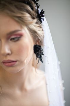 Black flower earrings. The flower earrings are made of preserved Ruscus leaves and other arranging material. Matching headpiece: https://www.etsy.com/uk/listing/1159358077/black-flower-crown-black-wedding?click_key=88077da76150a9e5318e7872a4831787a5d54489%3A1159358077&click_sum=3ae0135e&ref=shop_home_active_1 When stored in dry and dark place, our products last 10-15 years. We can also make you other matching accessories. Please message me for more information. :) ------------------------------- Black Wedding Earrings, Black Single Earring For Wedding, Elegant Black Flower Earrings For Wedding, Single Flower Earring For Wedding, Wedding Single Flower Earring, Wedding Single Flower Shaped Earring, Pierced Flower Wedding Earrings, Pierced Flower Shaped Wedding Earrings, Flower Shaped Wedding Earrings