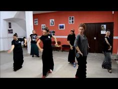 a group of people that are standing up in the middle of a dance floor together