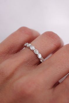 a woman's hand with a diamond ring on it