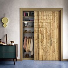 an open closet with wooden doors and clothes hanging on the shelves in front of it