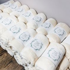 a pile of white blankets sitting on top of a wooden floor next to each other