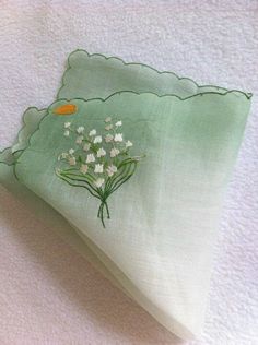 a green napkin with white flowers on it