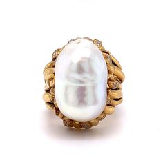 This Mid-Century inspired cocktail ring truly shines! A stunning Mabe pearl is the centerpiece of the ring, surrounded by forty (40) round brilliant cut diamonds. The diamonds measure 1.6 mm and weigh .018 carats each. This ring is sure to make a statement, whether you wear it for a night out or save it as a special heirloom. A timeless addition to any jewelry collection. Baroque Ring, Diamond Cocktail Ring, Mabe Pearl, Diamond Cocktail Rings, Pearl Diamond, Shop Engagement Rings, Round Brilliant Cut Diamond, Cocktail Ring, Brilliant Cut Diamond