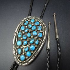 "VINTAGE NAVAJO BOLO TIE DESCRIPTION: Breathtaking specimens of high blue Morenci turquoise set in heavy gauge sterling silver, with hand-stamped border and a field of applied raindrops. This bolo will be a treasured addition to your collection of fine vintage Native American jewelry. MEASUREMENTS: Cord measures 40\" end to end Slide measures 3\" x 1 7/8\" Sterling tips measure 1 3/4\" long WEIGHT: 60.4 grams (including cord) SIGNED: no (Navajo) STERLING: yes, stamped STERLING" Western Style Engraved Blue Jewelry, Blue Western Style Jewelry With Inlay, Traditional Blue Concho Jewelry, Vintage Stamped Blue Jewelry, Blue Vintage Stamped Jewelry, Turquoise Stone Jewelry, Jewelry Measurements, Morenci Turquoise, Silversmith Jewellery