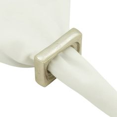 a close up of a white toilet paper dispenser with a metal handle