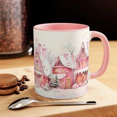 a pink coffee mug sitting on top of a wooden cutting board next to a cookie