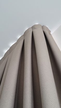 the side of a curtain that is closed in front of a white wall and ceiling