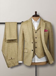 Aim for a lavish take on a casual style with our Highlander Heavy Beige Herringbone Tweed Suit. Most significantly, crafted from a pure wool material expresses a thick, decently rugged and gorgeously soft texture with a distinctive herringbone weave over a brown hue. Additionally, the cloth exudes an enormously cozy vibe, which makes this suit an excellent investment for the winter. Primarily, the precise tailoring suit frames the contour and ensures you look sharp for a charming profile while conducting business or attending a social occasion.  Look Includes  Highlander Heavy Beige Herringbone Tweed Fabric  Two Button Jacket Style  Notch Lapel   Horn Brown  Buttons  Single Vent  Three Cuff Buttons  Two Welted Back Pockets on Trousers   Click 'Customize Now' to modify the look if needed. Winter Semi-formal Tweed Three-piece Suit, Semi-formal Winter Tweed Three-piece Suit, Wool Three-piece Suit With Welt Pockets For Winter, Fitted Tweed Blazer With Herringbone Pattern, Tweed Three-piece Business Suit For Fall, Business Tweed Three-piece Suit For Fall, Winter Tweed Three-piece Suit, Fall Business Tweed Three-piece Suit, Elegant Fitted Tweed Three-piece Suit