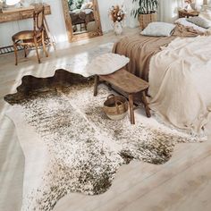 a bedroom with white walls and wooden floors