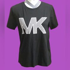 a black t - shirt with the letter mk printed on it's chest