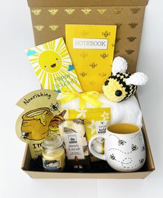 a gift box with honey, coffee mug and other items