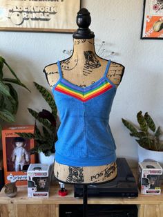 1970s nostalgia to the T (get it ☺️)! Lovely baby blue terry cloth tank top with rainbow design along the neckline. Definitely has a little stretch to it. In excellent condition! Measurements: Chest 15.5" Waist 12.25" Length 18" Multicolor Sleeveless Tank Top For Loungewear, Light Blue Sleeveless Tank Top For Loungewear, Blue Cotton Tank Top For Loungewear, Multicolor Sleeveless Tops For Loungewear, Vintage Sleeveless Tops For Loungewear, Blue Cotton Top With Rainbow Print, Retro Multicolor Tank Top, Retro Rainbow Cotton Tops, Casual Rainbow Sleeveless Top