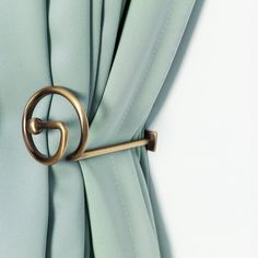 an open curtain with a metal hook on it