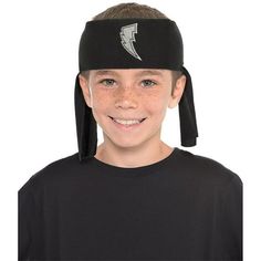 a young boy wearing a black headband with white lightning on it